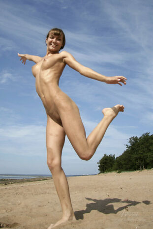 Entirely naked cherry beats fine solo poses while on a sandy