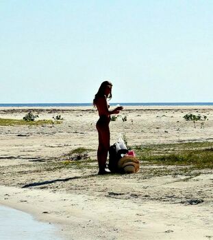 Slim and tall teenage model Katya posing on beach downright