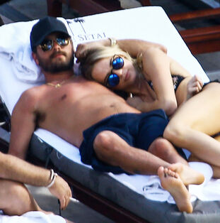Scott Disick Lounges Poolside With Mystery Blond Images
