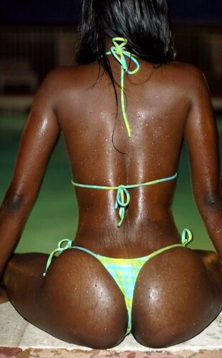 Dark skinned stunner with flawless bod posing in the pool..