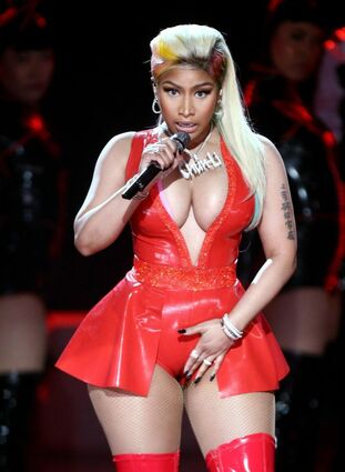 Nicki Minaj straddles a glittery horse and writhes on the fl