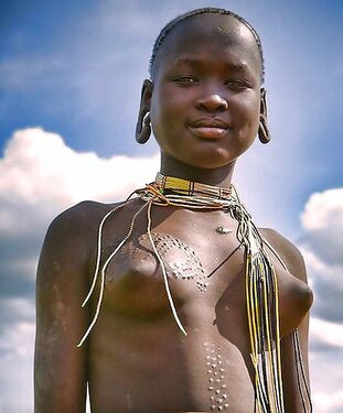 Bare gals from african tribe, stripped to the waist..