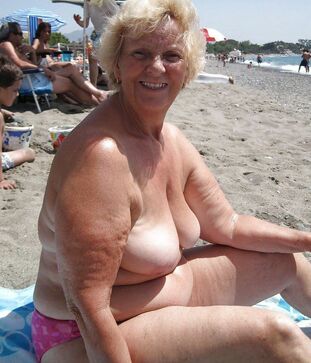 Bare Plump granny sunning on the beach