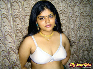 Lush Indian female Neha lets out her melons from milky bra