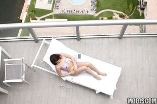 Black-haired nubile Kylie Quinn caught draining on balcony..