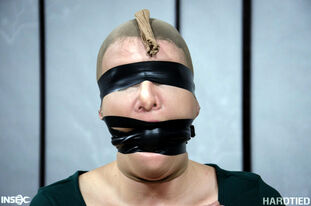 Ball-gagged and blinded sub strapped and cropped in harsh